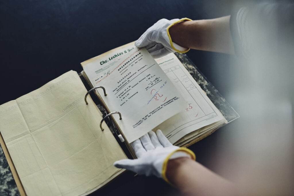 Päsentation von Dokumenten während einer Führung im Archiv Baumeister